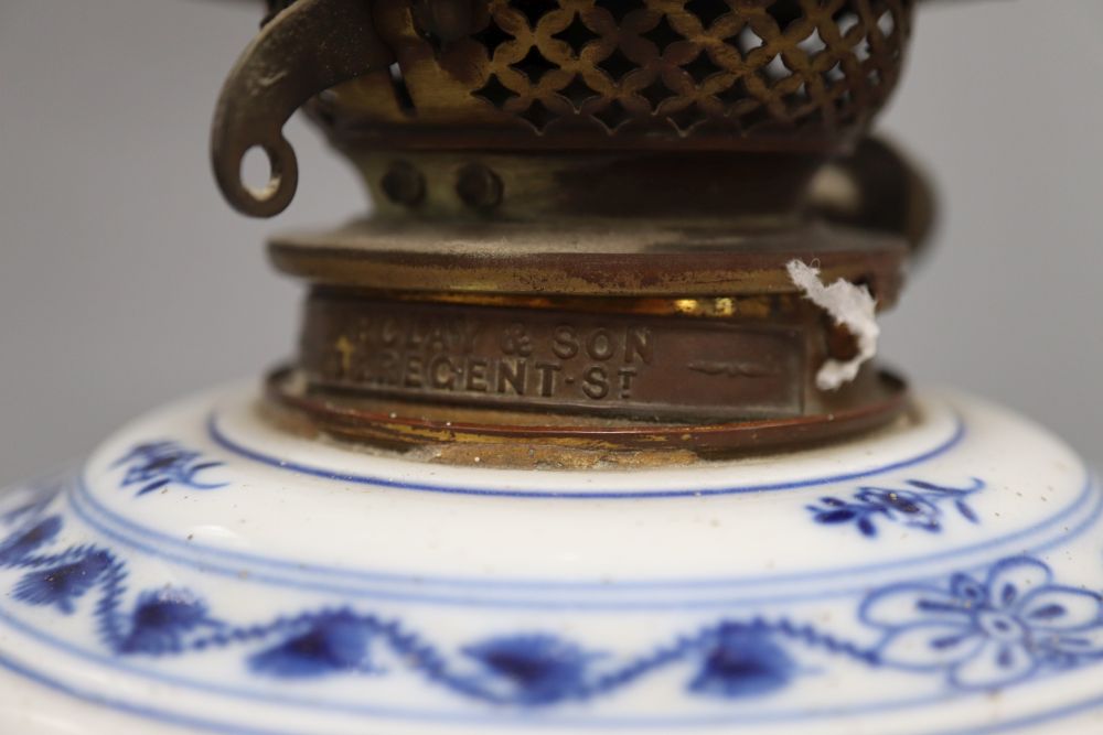 A Meissen onion pattern oil lamp, with cranberry shade